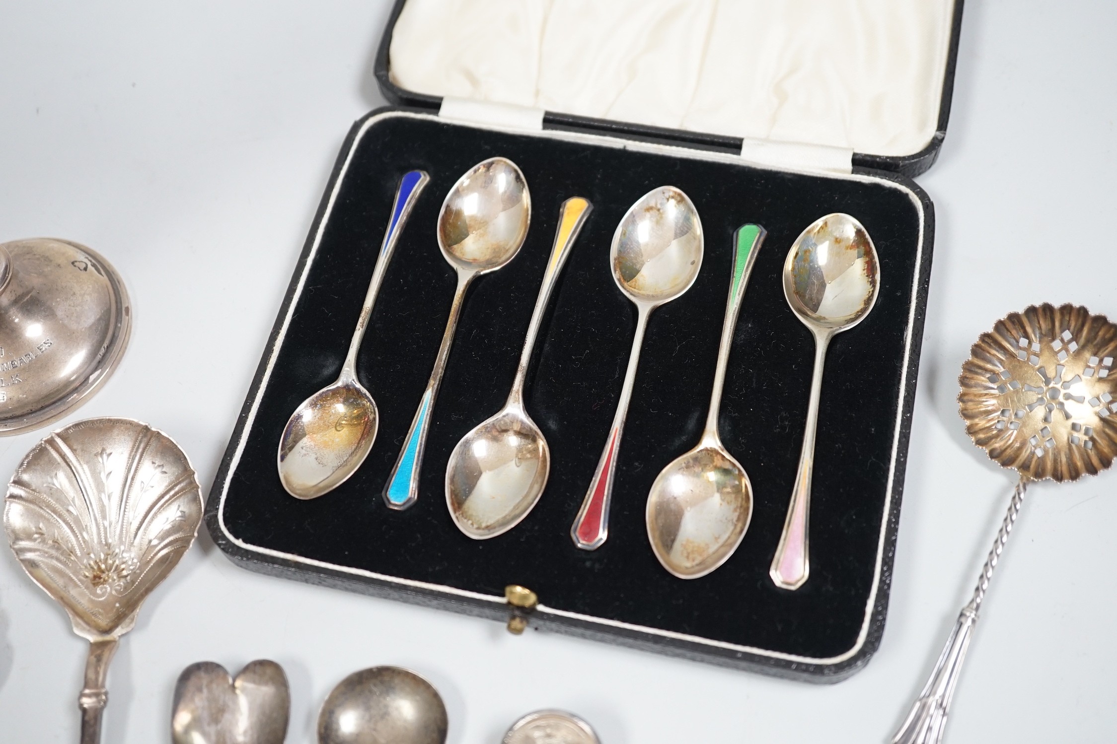 A cased set of six Edwardian silver and enamel teaspoons, William Hair Haseler, Birmingham,1913 and a collection of silver spoons and two silver mounted specimen vases.